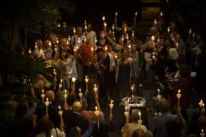 The Temple Israel Atrium filled with people holding candles during the Slichot Service