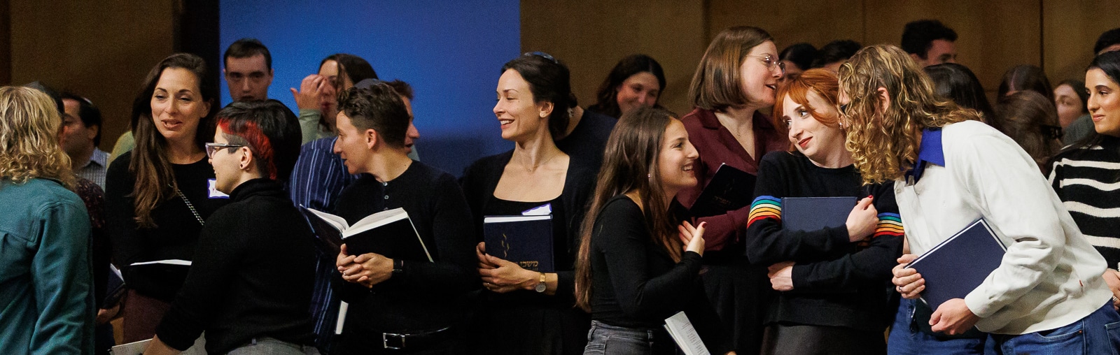 Young adults greeting each other at Riverway Shabbat