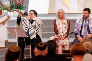 Rabbi Jacobson blowing the shofar with the other clergy sitting nearby.