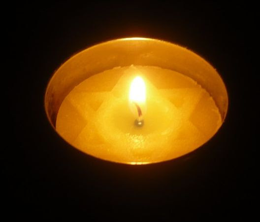 Yahrtzeit candle with the shape of a Jewish star in the wax