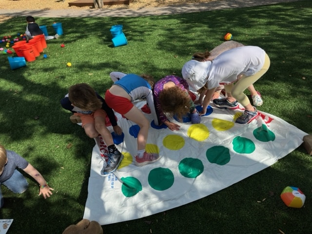 Children playing Twister on the lawn