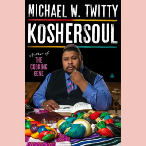 Koshersoul by Michael W. Twitty book cover with a picture of the  author seated at a table with very brightly colored loaves of challah